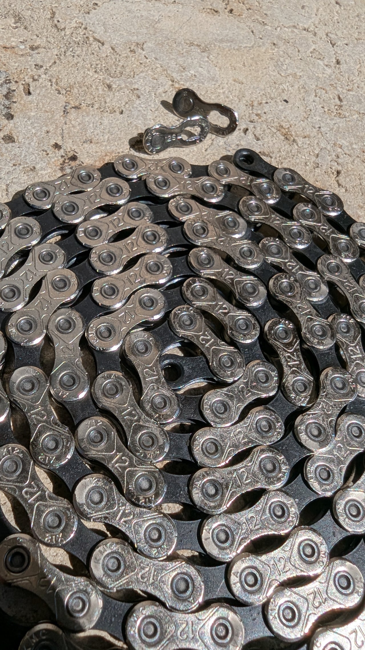 Detailansicht der KMC X12 12-fach Fahrradkette mit Molten Speed Wax Vorbehandlung und KMC MissingLink Kettenschloss
